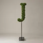 Monogram letter J topiary in Roman style, packed with green moss, on an adjustable stand