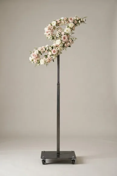Monogram letter J topiary in script style, covered in pink and white roses