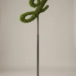 Monogram letter J topiary in Script style, packed with green moss, on an adjustable stand