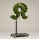 Monogram letter K topiary in Custom style, packed with green moss, on an adjustable stand