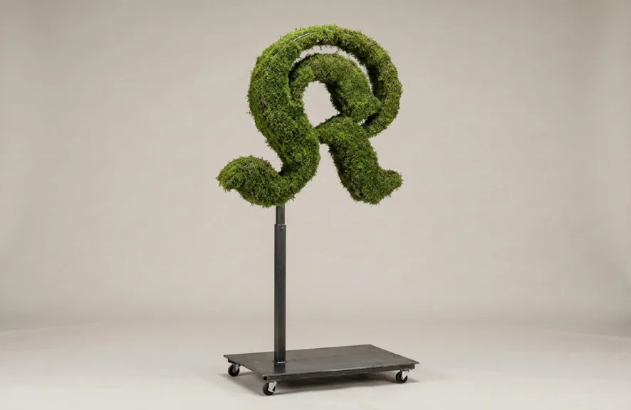 Monogram letter K topiary in Custom style, packed with green moss, on an adjustable stand