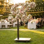 Monogram letter K topiary covered in flowers as a photo backdrop at a garden wedding