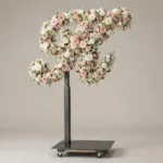Monogram letter K topiary in script style, covered in pink and white roses