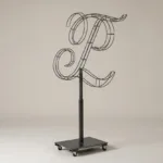 Monogram letter L topiary frame in Custom style, bare galvanized steel on an adjustable stand