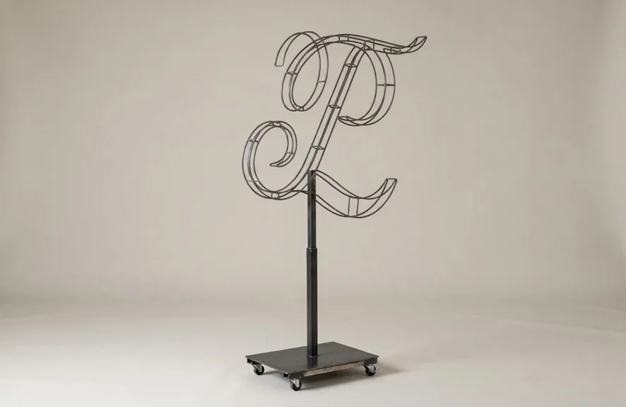 Monogram letter L topiary frame in Custom style, bare galvanized steel on an adjustable stand