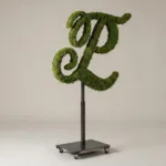 Monogram letter L topiary in Custom style, packed with green moss, on an adjustable stand