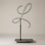 Monogram letter L topiary frame in Flowing script style, bare galvanized steel on an adjustable stand