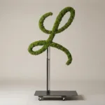 Monogram letter L topiary in Flowing script style, packed with green moss, on an adjustable stand