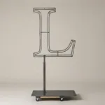 Monogram letter L topiary frame in Roman style, bare galvanized steel on an adjustable stand