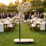 Monogram letter L topiary covered in flowers as a photo backdrop at a garden wedding