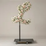 Monogram letter L topiary in script style, covered in pink and white roses