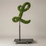 Monogram letter L topiary in Script style, packed with green moss, on an adjustable stand