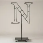 Monogram letter N topiary frame in Cinzel style, bare galvanized steel on an adjustable stand