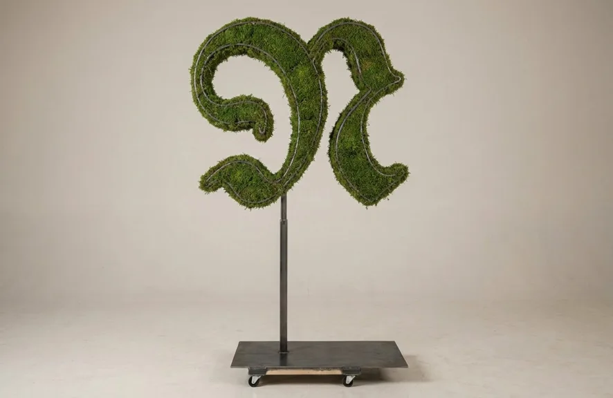 Monogram letter N topiary in Custom style, packed with green moss, on an adjustable stand