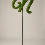 Monogram letter N topiary in Flowing script style, packed with green moss, on an adjustable stand