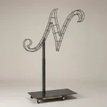 Monogram letter N topiary frame in Script style, bare galvanized steel on an adjustable stand
