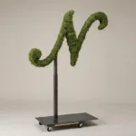 Monogram letter N topiary in Script style, packed with green moss, on an adjustable stand