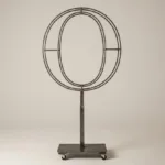 Monogram letter O topiary frame in Cinzel style, bare galvanized steel on an adjustable stand
