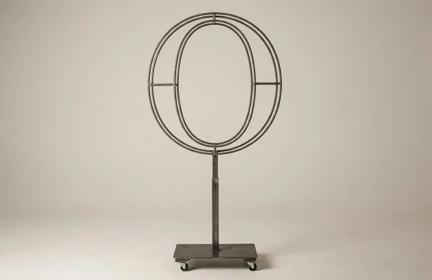 Monogram letter O topiary frame in Cinzel style, bare galvanized steel on an adjustable stand