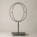 Monogram letter O topiary frame in Roman style, bare galvanized steel on an adjustable stand