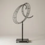 Monogram letter O topiary frame in Script style, bare galvanized steel on an adjustable stand
