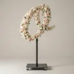 Monogram letter O topiary in script style, covered in pink and white roses