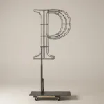 Monogram letter P topiary frame in Roman style, bare galvanized steel on an adjustable stand