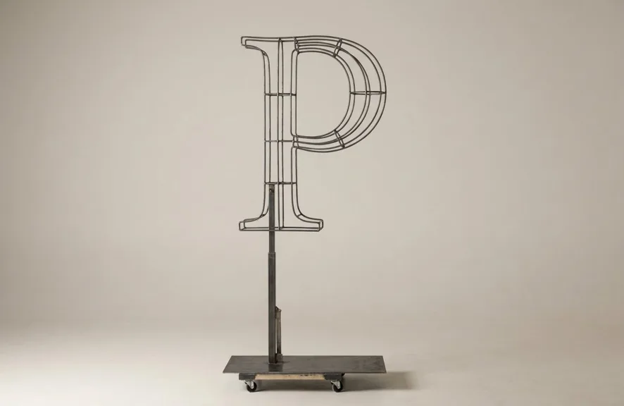 Monogram letter P topiary frame in Roman style, bare galvanized steel on an adjustable stand