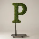 Monogram letter P topiary in Roman style, packed with green moss, on an adjustable stand