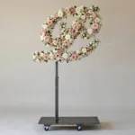 Monogram letter P topiary in script style, covered in pink and white roses