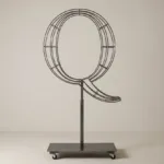 Monogram letter Q topiary frame in Roman style, bare galvanized steel on an adjustable stand