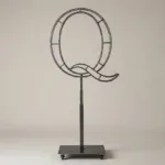 Monogram letter Q topiary frame in Script style, bare galvanized steel on an adjustable stand