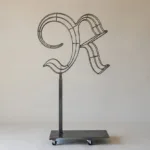 Monogram letter R topiary frame in Custom style, bare galvanized steel on an adjustable stand