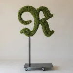 Monogram letter R topiary in Custom style, packed with green moss, on an adjustable stand