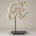 Monogram letter R topiary in script style, covered in pink and white roses