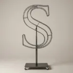 Monogram letter S topiary frame in Cinzel style, bare galvanized steel on an adjustable stand