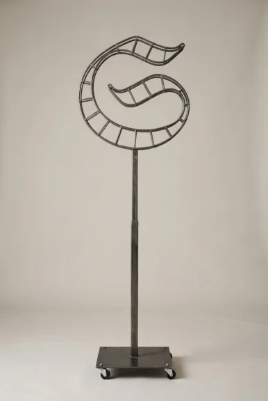 Monogram letter S topiary frame in Custom style, bare galvanized steel on an adjustable stand