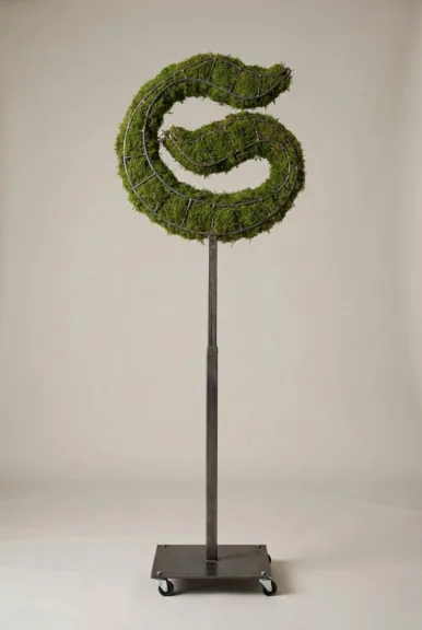 Monogram letter S topiary in Custom style, packed with green moss, on an adjustable stand