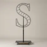 Monogram letter S topiary frame in Roman style, bare galvanized steel on an adjustable stand