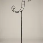 Monogram letter S topiary frame in Script style, bare galvanized steel on an adjustable stand
