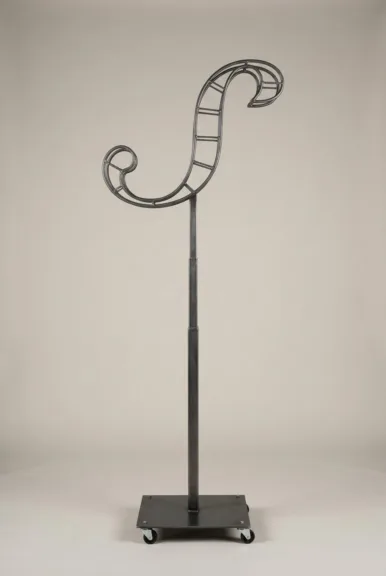 Monogram letter S topiary frame in Script style, bare galvanized steel on an adjustable stand