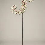 Monogram letter S topiary in script style, covered in pink and white roses