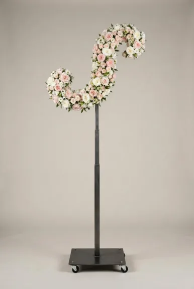 Monogram letter S topiary in script style, covered in pink and white roses