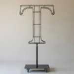 Monogram letter T topiary frame in Cinzel style, bare galvanized steel on an adjustable stand