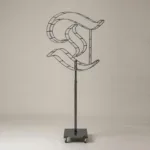 Monogram letter T topiary frame in Custom style, bare galvanized steel on an adjustable stand
