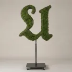 Monogram letter U topiary in Custom style, packed with green moss, on an adjustable stand