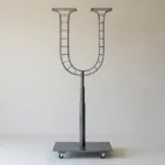 Monogram letter U topiary frame in Roman style, bare galvanized steel on an adjustable stand