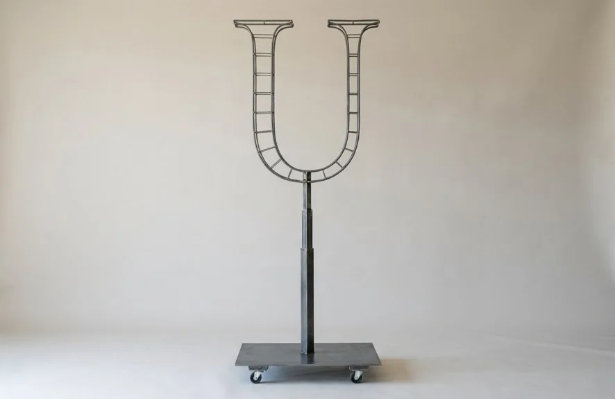 Monogram letter U topiary frame in Roman style, bare galvanized steel on an adjustable stand
