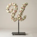 Monogram letter U topiary in script style, covered in pink and white roses