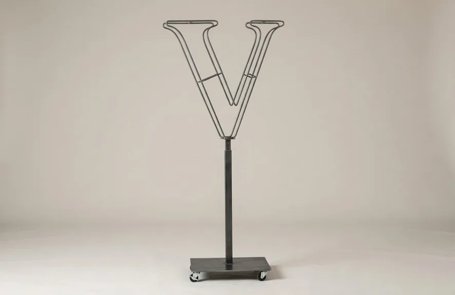 Monogram letter V topiary frame in Cinzel style, bare galvanized steel on an adjustable stand